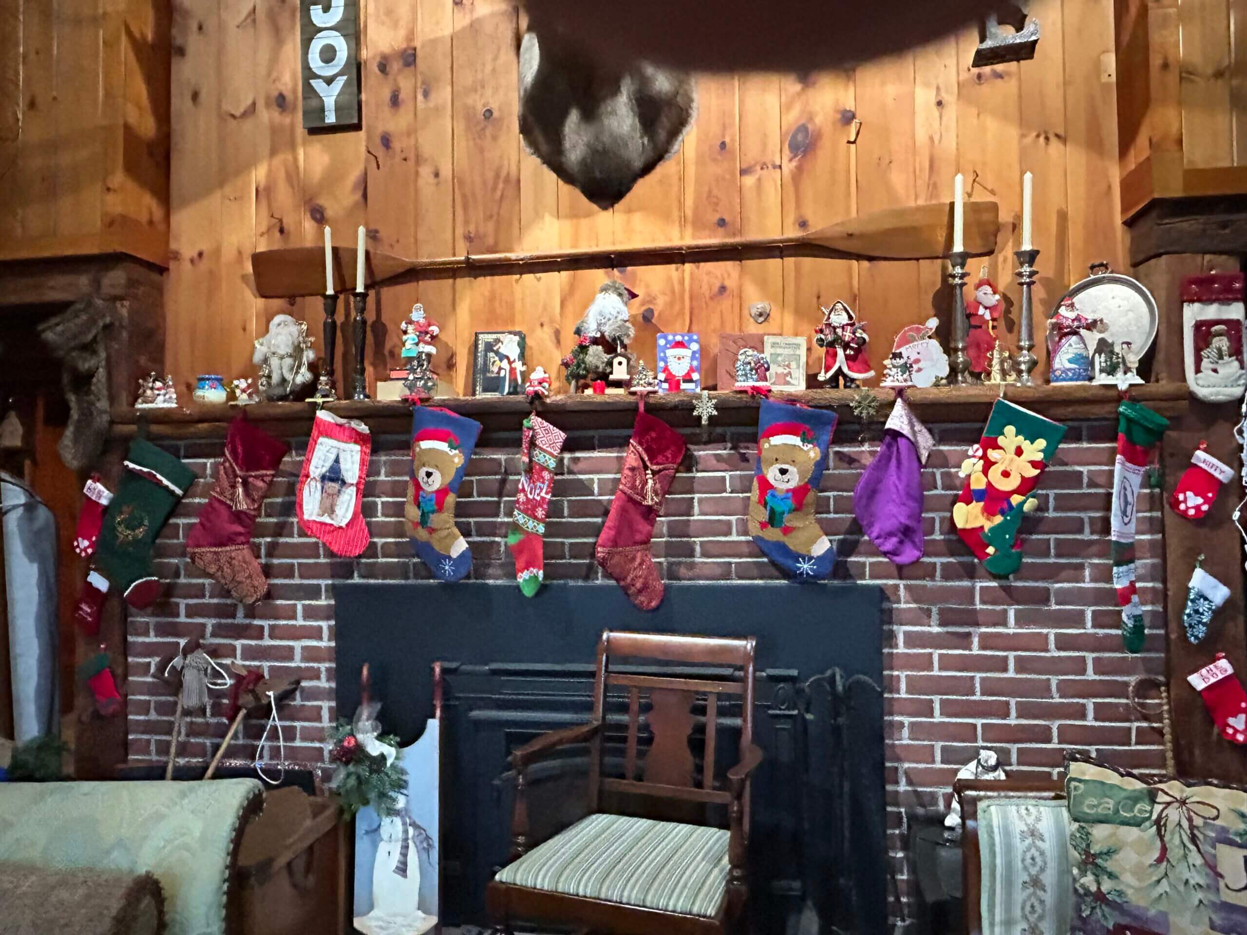 Fireplace mantle with Christmas stockings and decorations