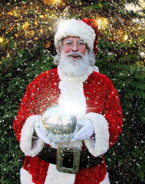 Santa Claus holding a glowing orb with a snowy effect.