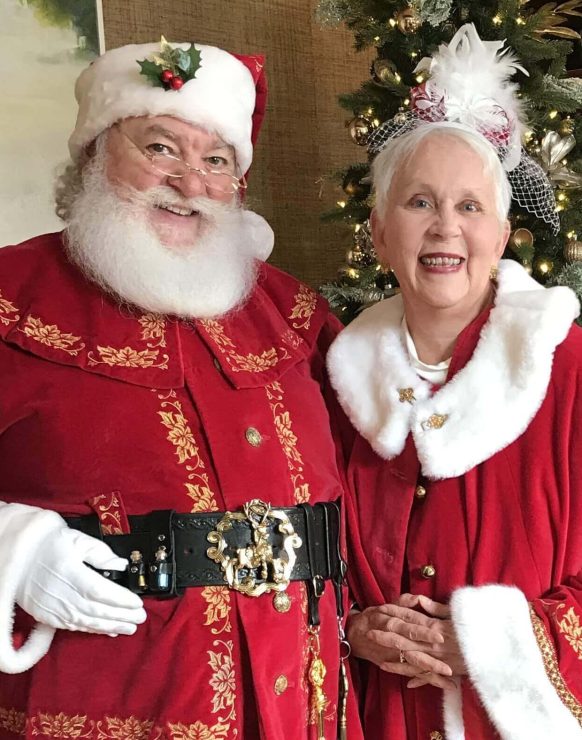 Santa Claus and Mrs. Claus dressed in festive red outfits.